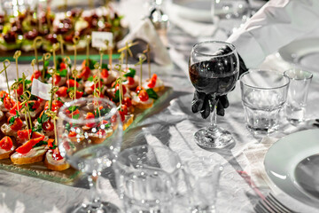 Waiter serving red wine glass in restaurant