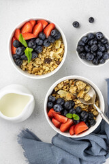 European breakfast with crispy granola, berries on a gray background top view