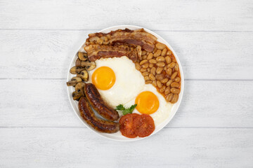 Traditional full english breakfast on white wooden background top view, copy space