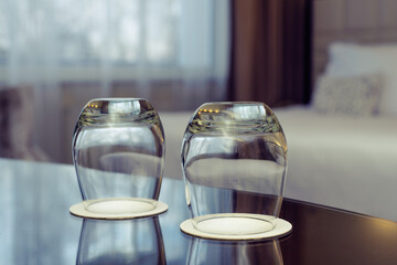Empty clean glasses on hotel room table