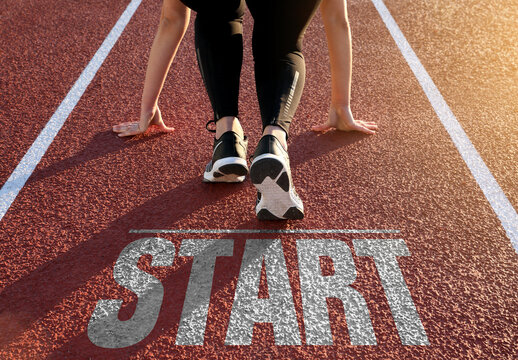 Running track with 'start' written on the floor and a woman is preparing to run on it