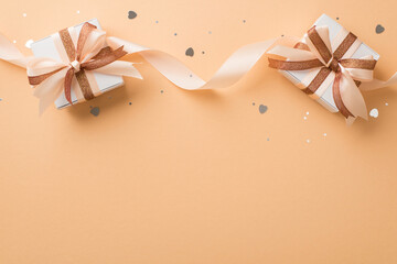 Top view photo of valentine's day decorations white gift boxes with glowing brown and light beige...