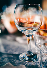 table in a restaurant with white tablecloth and empty glasses