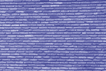 Background of old vintage brick wall texture, close up. Trendy color of the year 2022 . Ultra Violet creative and moody color of the picture