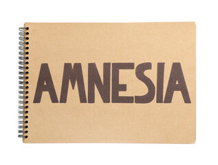 Notebook with word Amnesia on white background, top view