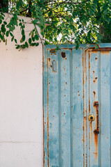 Vintage blue metal door and white wall