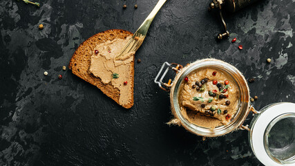 Croutons with liver pate. homemade chicken liver pate in a glass jar. Haute cuisine. Long banner format. top view