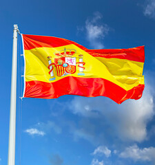 Spanish state flag waving in the wind against the sky