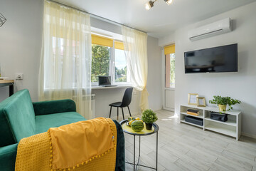 Interior of the modern living room or guestroom in studio apartments with sofa and tv