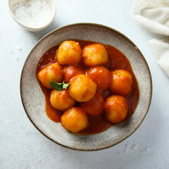 Traditional homemade dumplings with tomato sauce