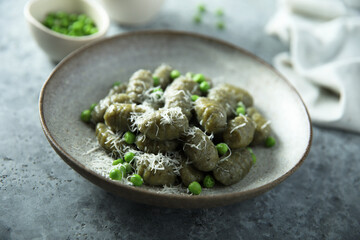 Homemade spinach gnocchi with green pea