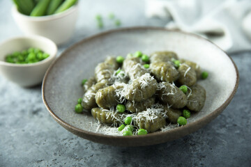 Homemade spinach gnocchi with green pea