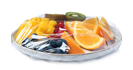 Tray of cut fruits wrapped with transparent plastic stretch film isolated on white