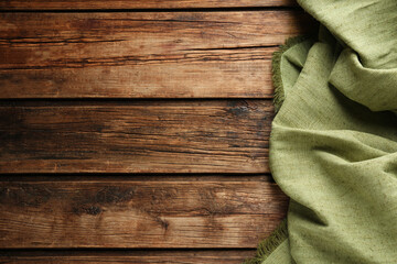 Natural burlap fabric on wooden table, top view. Space for text