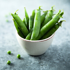 Fresh green pea in a white bowl