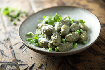 Homemade spinach gnocchi with green pea