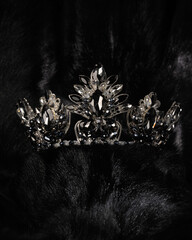 beautiful silver crown with black stone for miss beauty pageant on black shiny background, close-up © mira_y