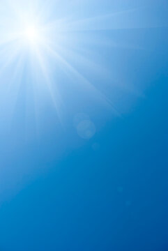 Blue summer sky with bright sun as background