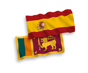 National vector fabric wave flags of Sri Lanka and Spain isolated on white background. 1 to 2 proportion.