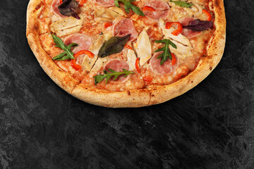 Tasty pizza on black concrete background. Top view of hot pizza. With copy space for text. Flat lay. Banner.
