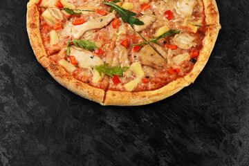 Tasty pizza on black concrete background. Top view of hot pizza. With copy space for text. Flat lay. Banner.