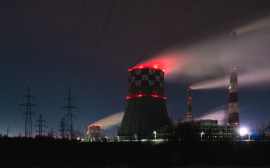 thermal power plant cooling towers soar in winter at night