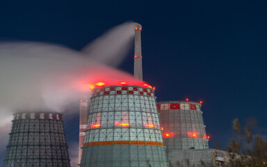 thermal power plant cooling towers soar in winter at night