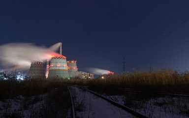 thermal power plant cooling towers soar in winter at night