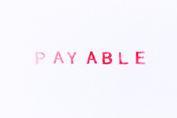 Red color ink rubber stamp in word payable on white paper background