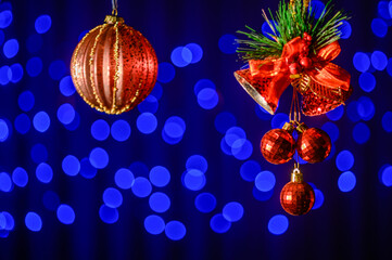 red beautiful Christmas tree toy on the background of a blue garland in bokeh1