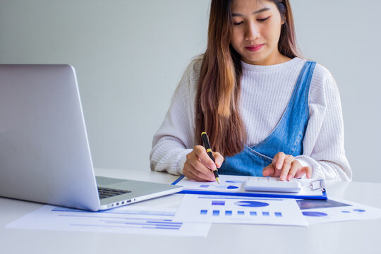 Finance worker calculates company's past sales and expenses, cropped image of working woman of own company by self-checking and troubleshooting, modern businesswomen concept.