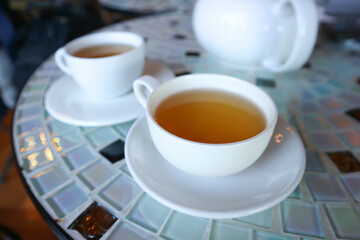 hot tea , tea cup and kettle