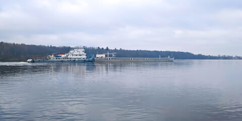 close-up river panorama with a cargo ship in the background 