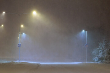 strong snow storm. empty night road in a blizzard.