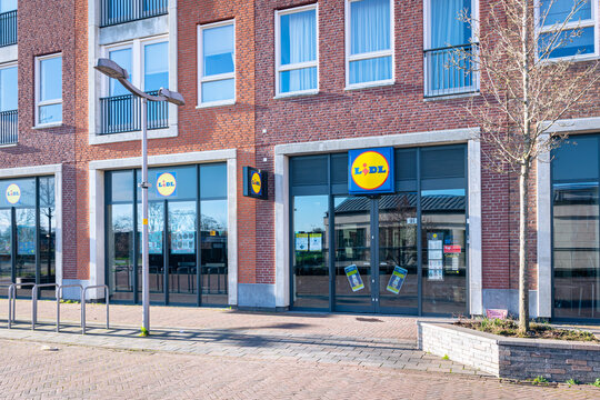 Waddinxveen, Netherlands - December 2021: Store of supermarket chain Lidl in a shopping street.