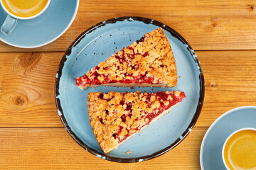 Closeup two piece of homemade raspberries pie with streisel on wooden table. Top view.