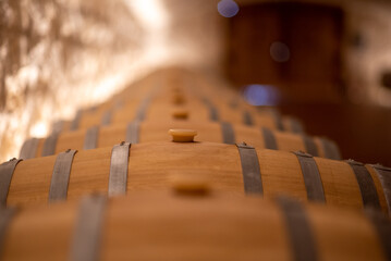 wooden wine barrels wine in a winery, close up of wine cellar 