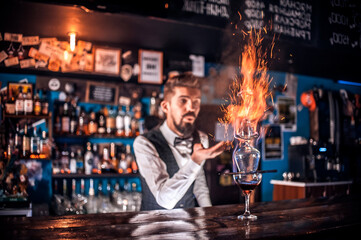 Bartender makes a cocktail behind the bar