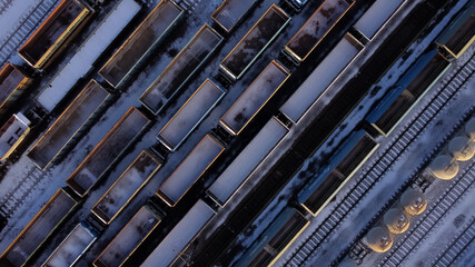 Close up air view view of railway wagons on an industrial railroad during the winter