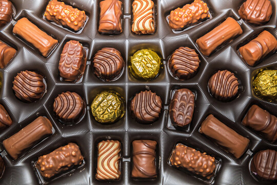 Chocolates In A Box. Flat Lay. Assortment of various chocolate and mocha bites in a box. Stock Image.