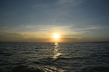 Fototapeta premium Seascape with a beautiful sunset, there are fishing nets in the sea