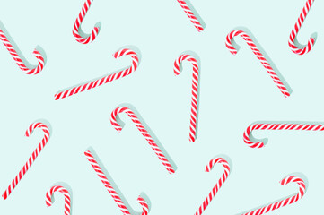 Lollipop candy cane on a pastel green background. Sweet food Christmas concept.