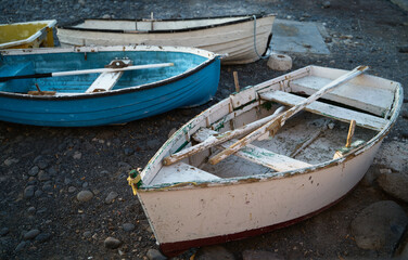 Old scratched fisher boats on the oceanfront in Costa Adeje, Tenerife