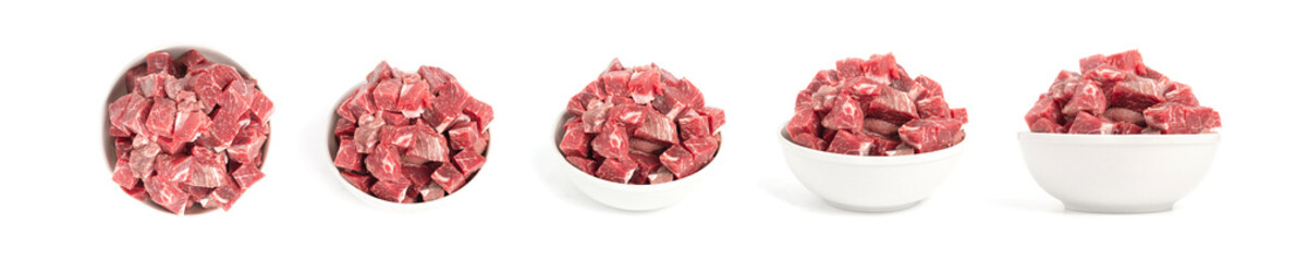 Raw beef cubes in a white ceramic bowl, fresh, natural dog or cat food, isolated on a white background at different angles, high-resolution billboard banner