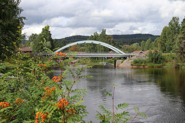 Cloudy summer day in Järvsö, view at a bridge over Ljusnan river between mainland and Island Kyrkön.