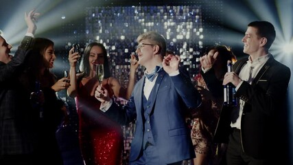 happy group of friends celebrating new years eve party dancing throwing confetti enjoying glamorous celebration wearing stylish fashion social gathering on rooftop at night 4k