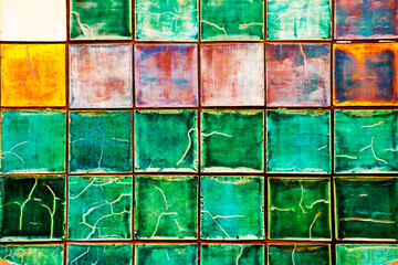 Colorful rusty and grunge tiled wall 