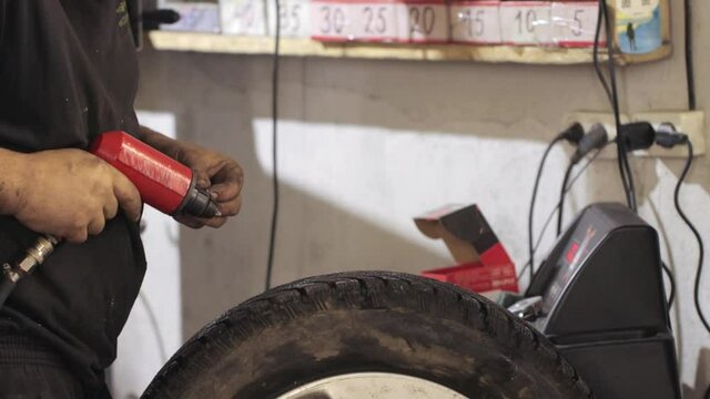 A man replacing old worn-out tire spikes