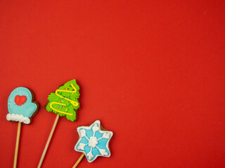 Gingerbread Deer, Mittens, Snowflake on a Red Background. Holiday concept.