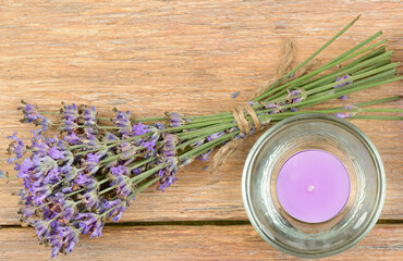 Obraz na płótnie Canvas Lavender flowers and scented candle on wooden background.